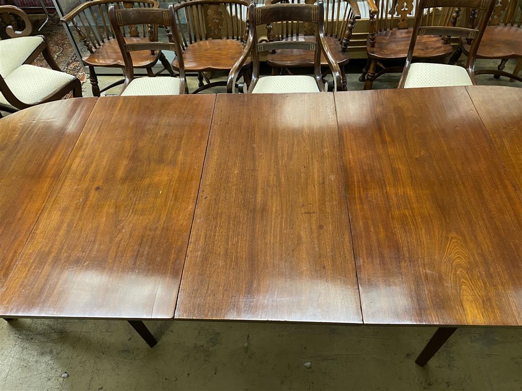 A George III mahogany D end dining table, on square tapered legs, with three spare leaves, 274cm extended, one spare leaf, width 107c